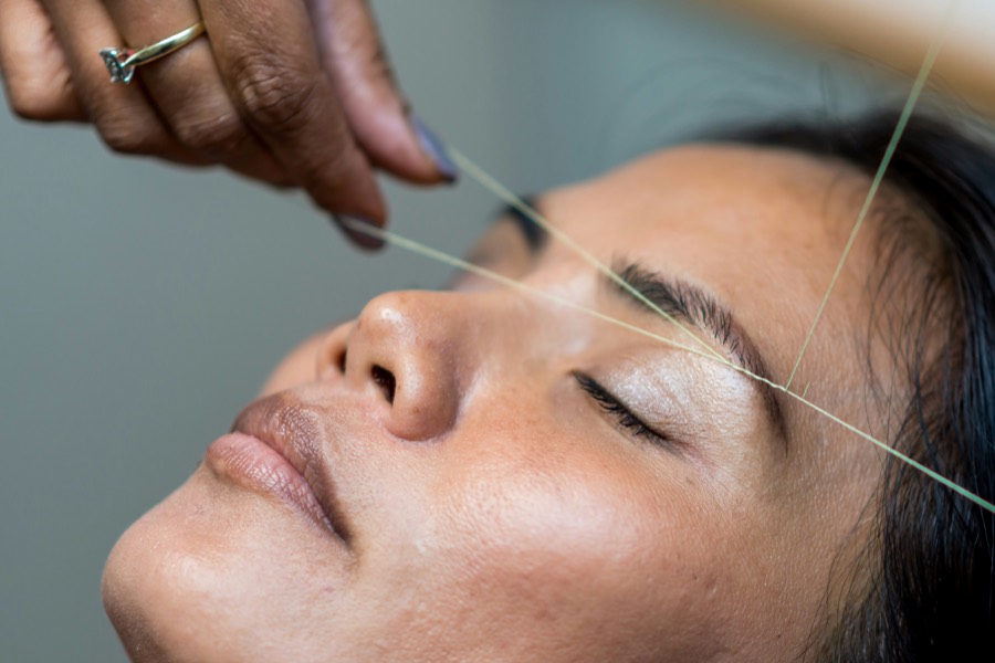 Eyebrow threading at a home salon